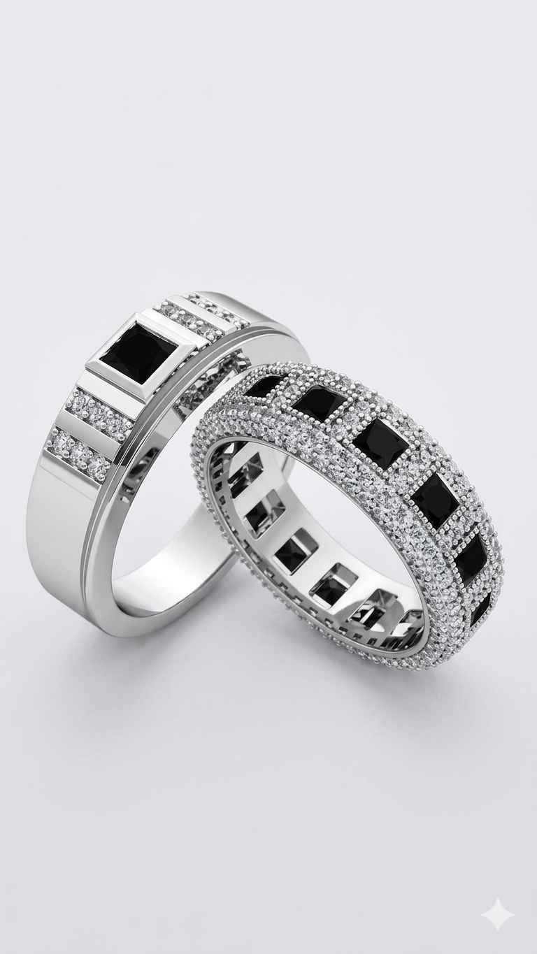 Two silver rings with black gemstones on a light gray background
